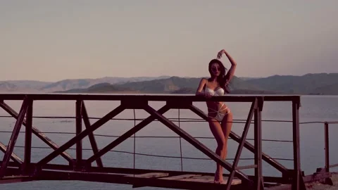 Girl in a bathing suit posing on the pier Stock Footage 138098488