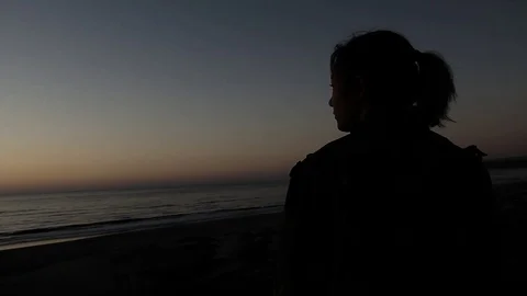 Girl on the beach at sunset Stock Footage 123201607