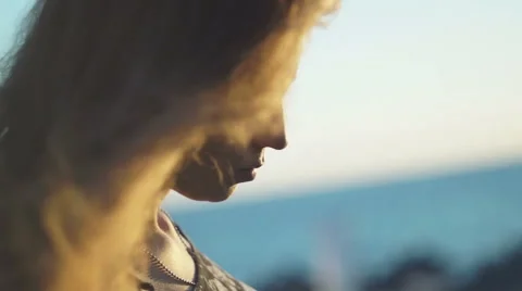 Girl on the beach. at sunset with her hair in the wind Stock Footage