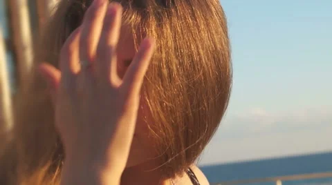 Girl on the beach. at sunset with her hair in the wind Stock Footage
