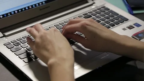 A girl with beautiful hands writes a script on her personal computer Vídeos de archivo 158909662