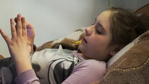 Girl on bed playing on smartphone Stock Footage 75002575