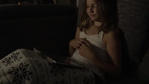 Girl in bed playing with tablet Stock Footage 77289860