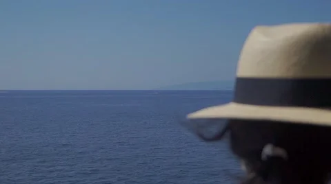 Girl From Behind with a Hat on the Sea Stock Footage