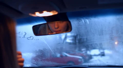 The girl behind the wheel of a car lipstick in the rearview mirror Video stock 59263994