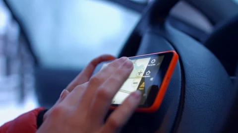 The girl behind the wheel of a car looking map of the city on a mobile phone Video stock 59265109