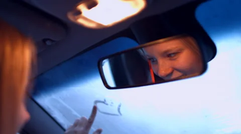 The girl behind the wheel of a car talking on the phone in the rearview mirror Video stock 59282675