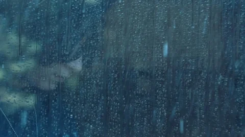 Girl behind window using smartphone in a rainy day. Shot in slowmotion Video stock 47867293