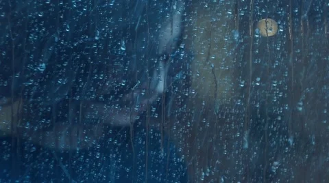 Girl behind window using smartphone in a rainy day. Shot in slowmotion Video stock 47874183
