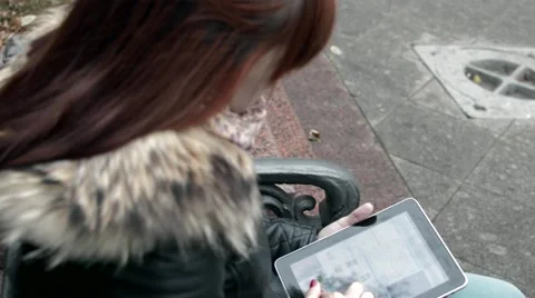 Girl on a bench with the Tablet Stock Footage 56278456