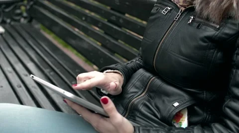 Girl on a bench with the Tablet Stock Footage 56278467