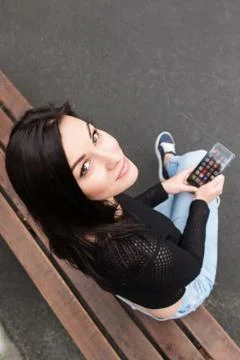 Girl on a bench with your phone Stock Photos