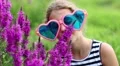 Girl in big sunglasses smells flowers HD Footage
