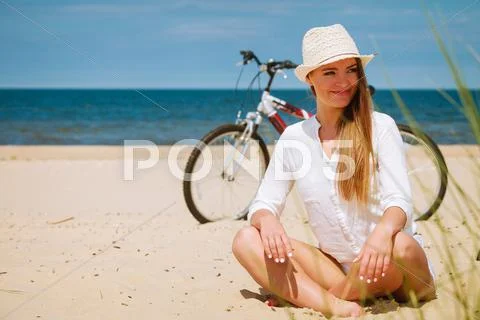 Girl With Bike On Beach.