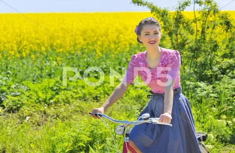 Girl on bike in spring time Stock Photos