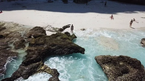 Girl in Bikini on Beautiful Beach While Camera Flying Away [Drone Footage] Stock Footage 96284888