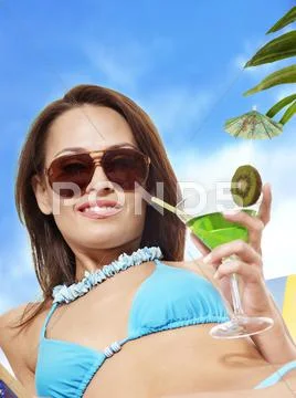Girl in bikini drinking cocktail. Stock Photos