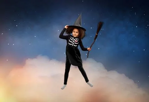 Girl in black witch hat with broom on halloween Stock Photos