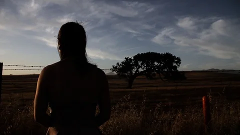 Girl blocked from tree by barb wire fence Stock Footage 99273339