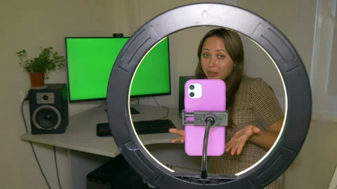 Girl blogger streams on a social network via phone with ring lamp lighting. Stock Footage 208009832