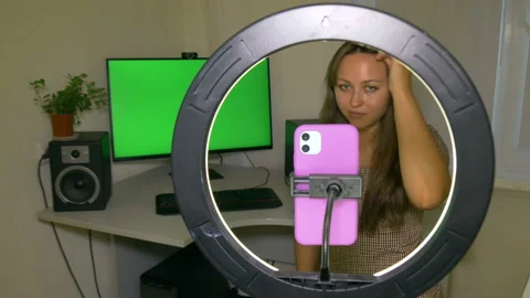 Girl blogger streams on a social network via phone with ring lamp lighting. Stock Footage 208009843