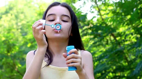 Girl blowing bubbles 스톡 동영상 22481218