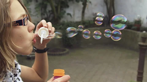 Girl blowing bubbles slow motion Stock Footage 57319507
