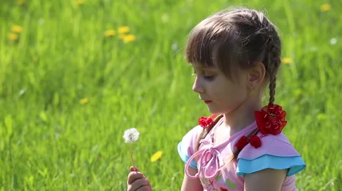 Girl blowing on a dandelion Stock Footage 62935290