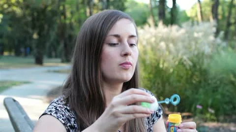 Girl blowing soap bubbles Stock Footage 19944610