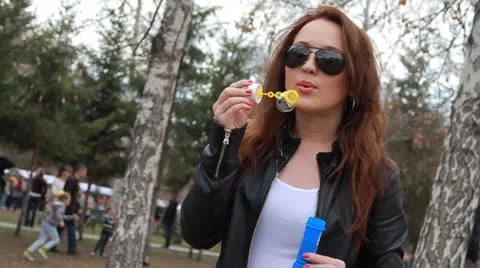 Girl blowing soap bubbles   Stock Footage 22972455