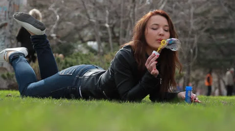 Girl blowing soap bubbles  動画素材 22972489