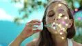 Girl blowing soap bubbles HD Footage