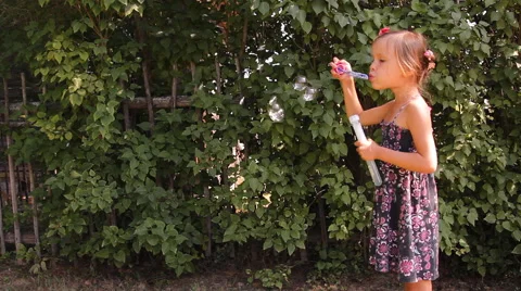 Girl blows bubbles Video stock 45329998