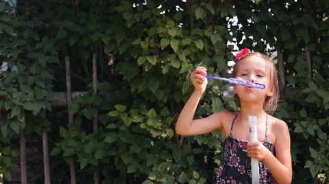 Girl blows bubbles Video stock 45344553