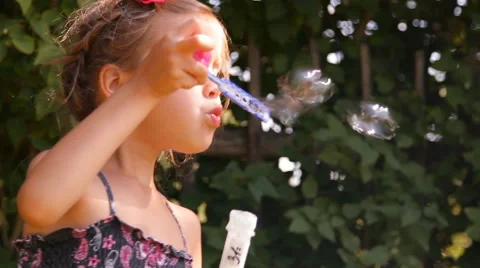 Girl blows bubbles Video stock 45344720