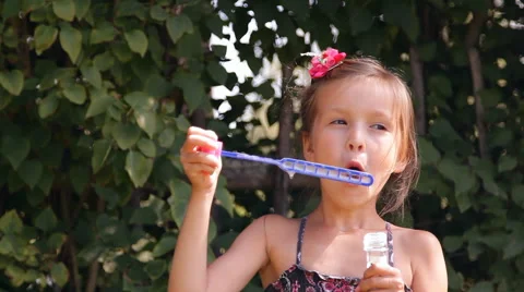 Girl blows bubbles Video stock 45375344