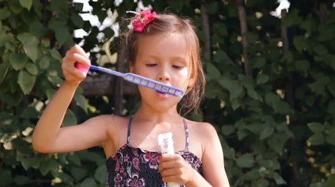 Girl blows bubbles Video stock 45375468