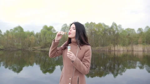 Girl blows bubbles Stock Footage 62442276
