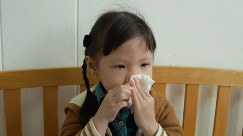 Girl blows his nose using toilet paper Stock Footage 86263596