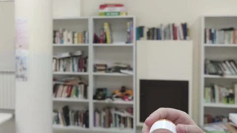 The Girl Blows Soap Bubbles in the Library. Happy Childhood.  Stock Footage 202340422