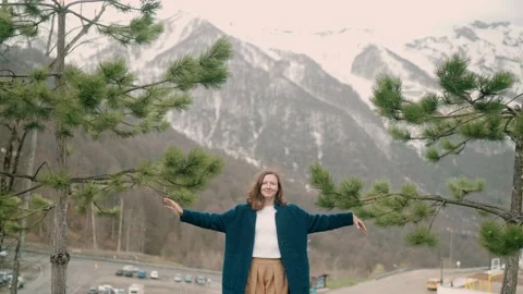 Girl in blue coat posing on camera in mountain in Roza Khutor Stock Footage 158694222