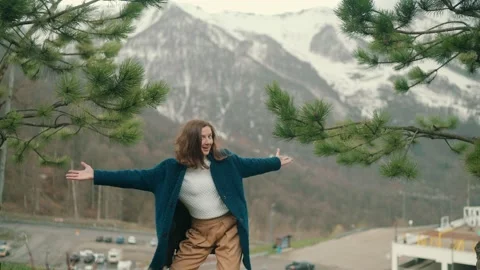 Girl in blue coat posing on camera in mountain in Roza Khutor Stock Footage 158694492