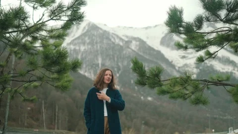 Girl in blue coat posing on camera in mountain in Roza Khutor Stock Footage 158697466