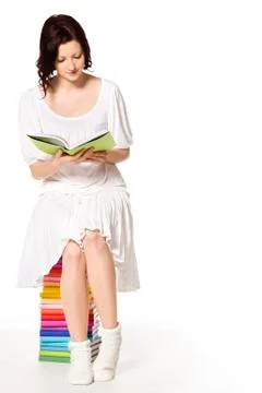 Girl on book stack reading. Stock Photos