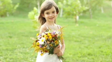 Girl with a bouquet of flowers spinning Stock Footage
