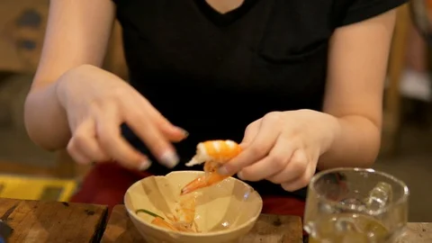 Girl breaks the shell from a prawn Stock Footage 97521684