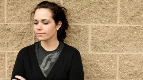 Girl with brick background thinking Stockbeeldmateriaal 660853