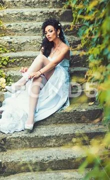 Girl with bridal makeup and hairstyle. Woman wear lace garter on leg. Sexy woman Stock Photos