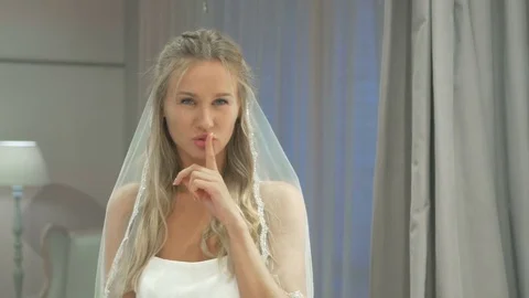 Girl in bridal veil send kiss in wedding boutique Stock Footage