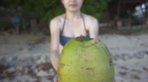 Girl Brings a Coconut to the Camera. Slow Motion Stock Footage 59149330